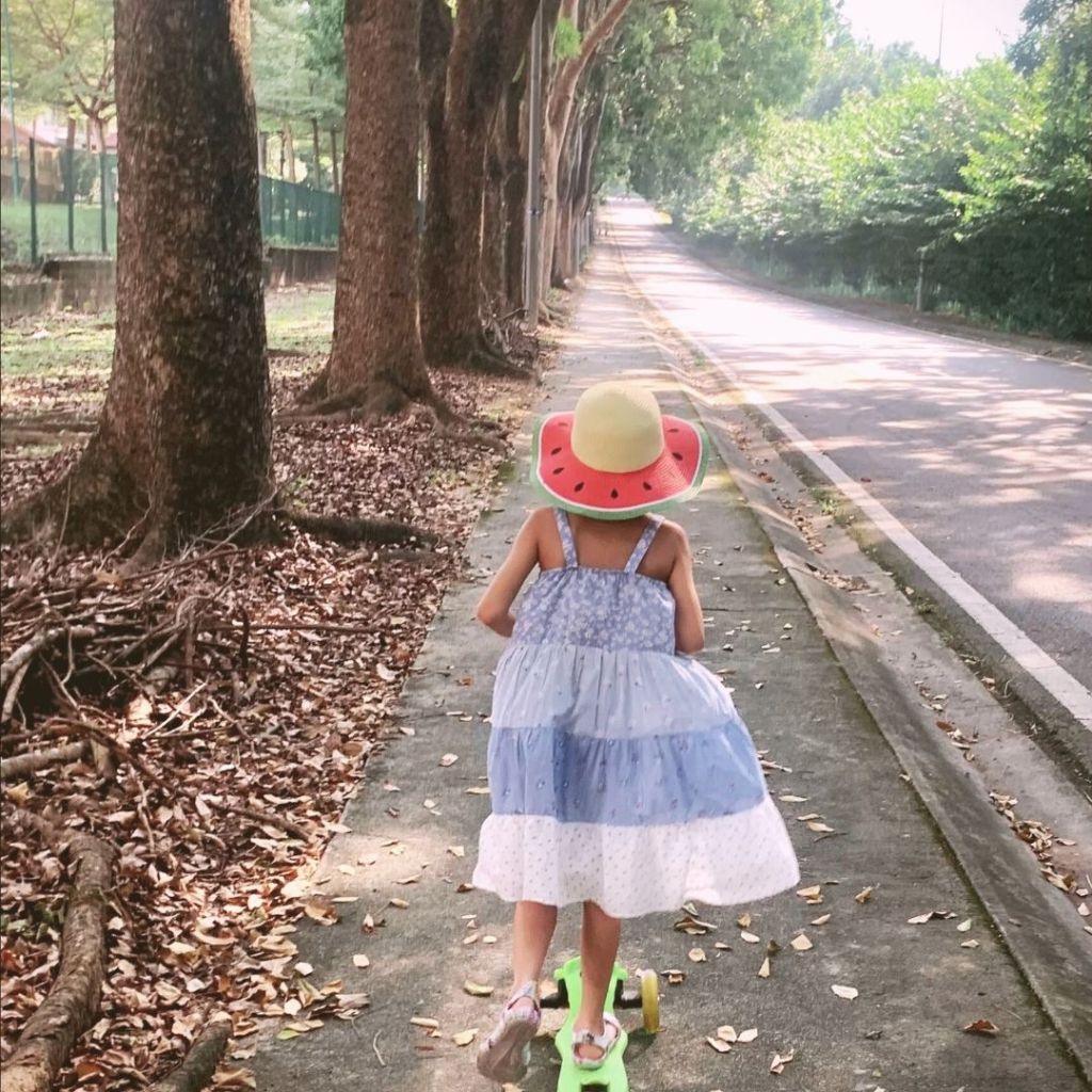 Child cancer patient taking her scooter outside. Sun and movement are great for recovery.